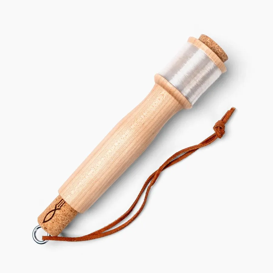 A maple handline fishing reel with a wound line and a leather wrist strap, photographed on white.