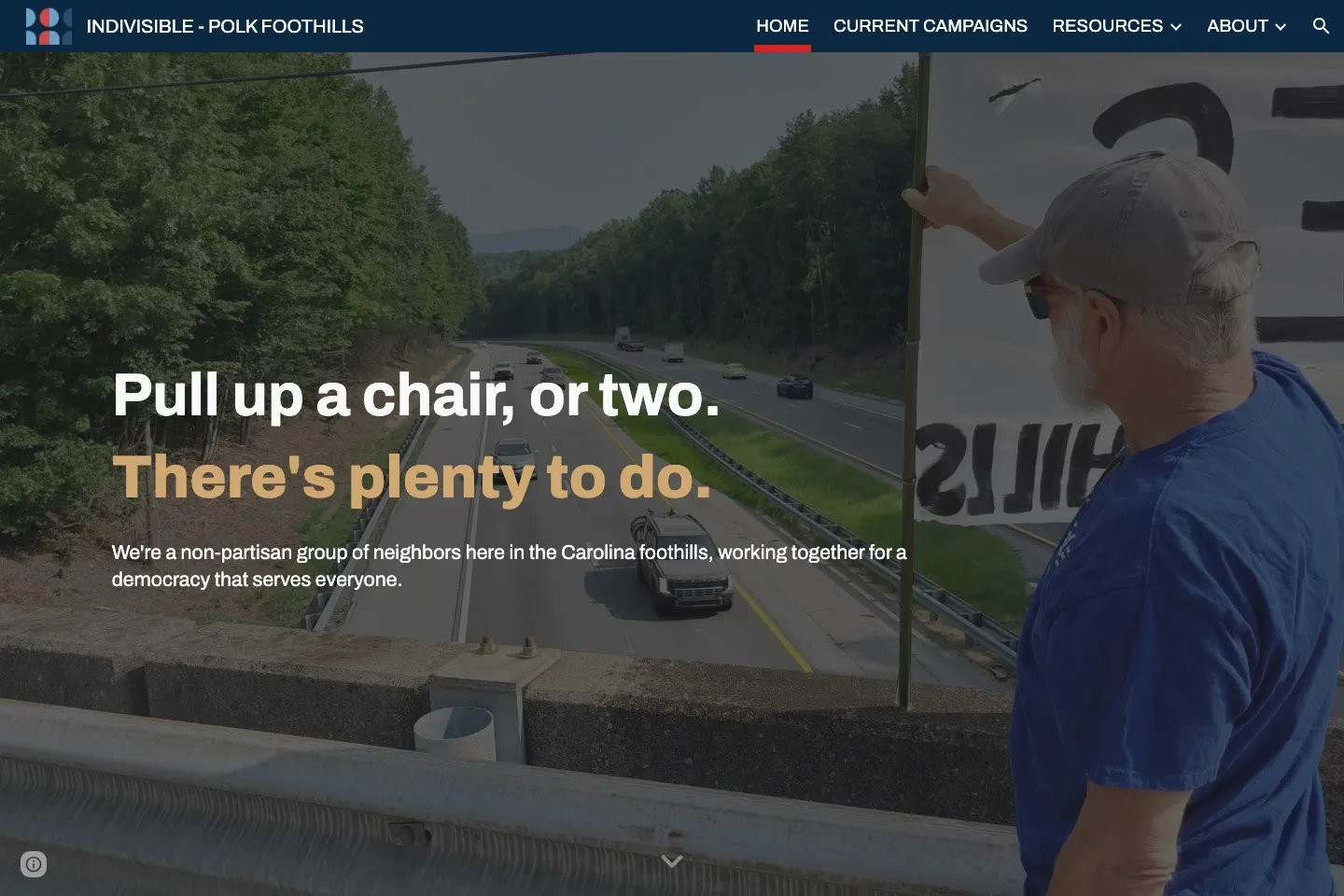 The live site: a petrol navigation bar over a photograph of a member holding a banner above the highway, with the headline "Pull up a chair, or two. There's plenty to do."